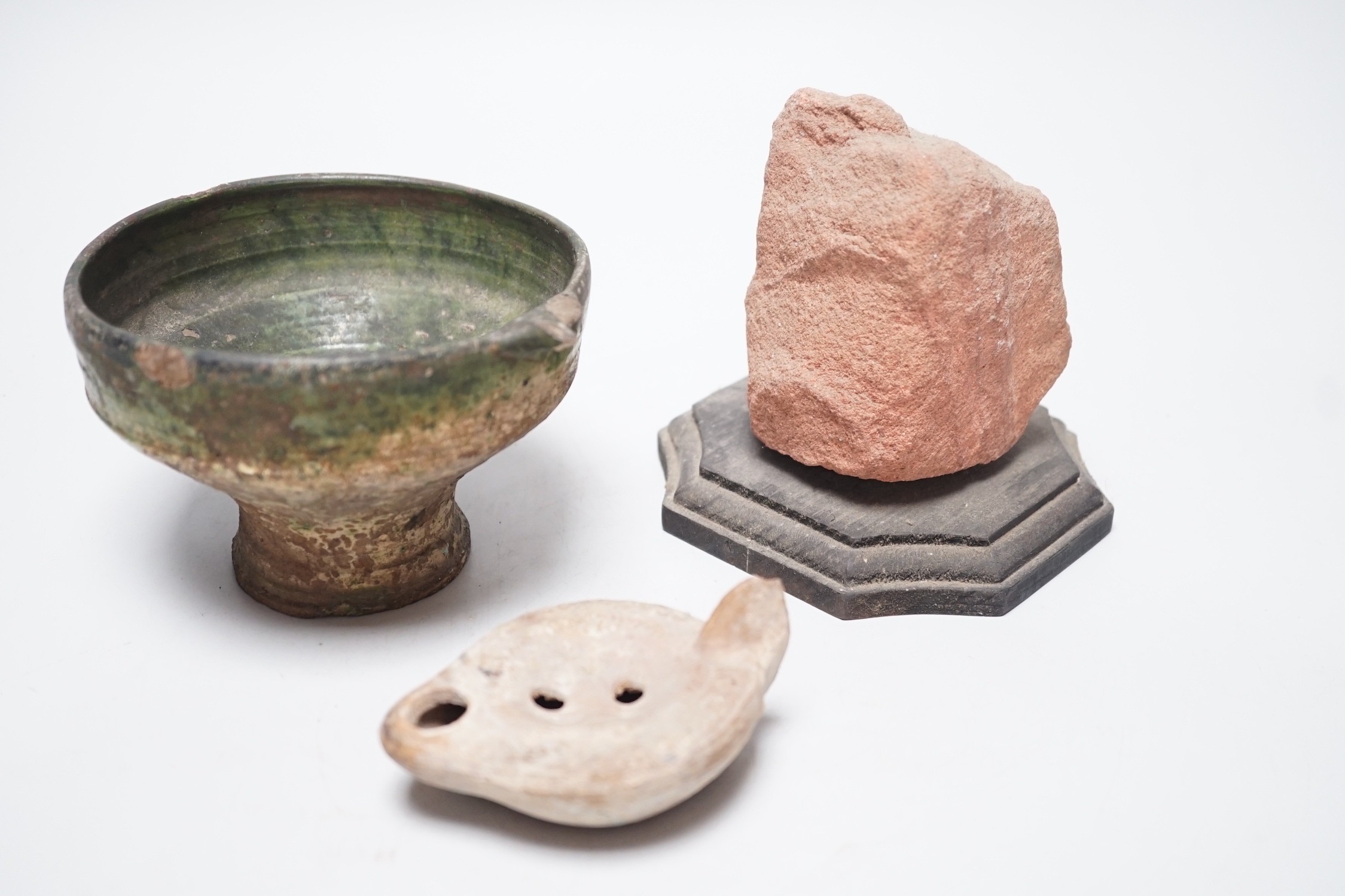 A Roman green glazed vessel, 13 cm wide and a pottery oil lamp, with letter of provenance dated 1942 stating that they were excavated 50-60 years previously during excavations for Lincoln’s Inn New chapel London and a se